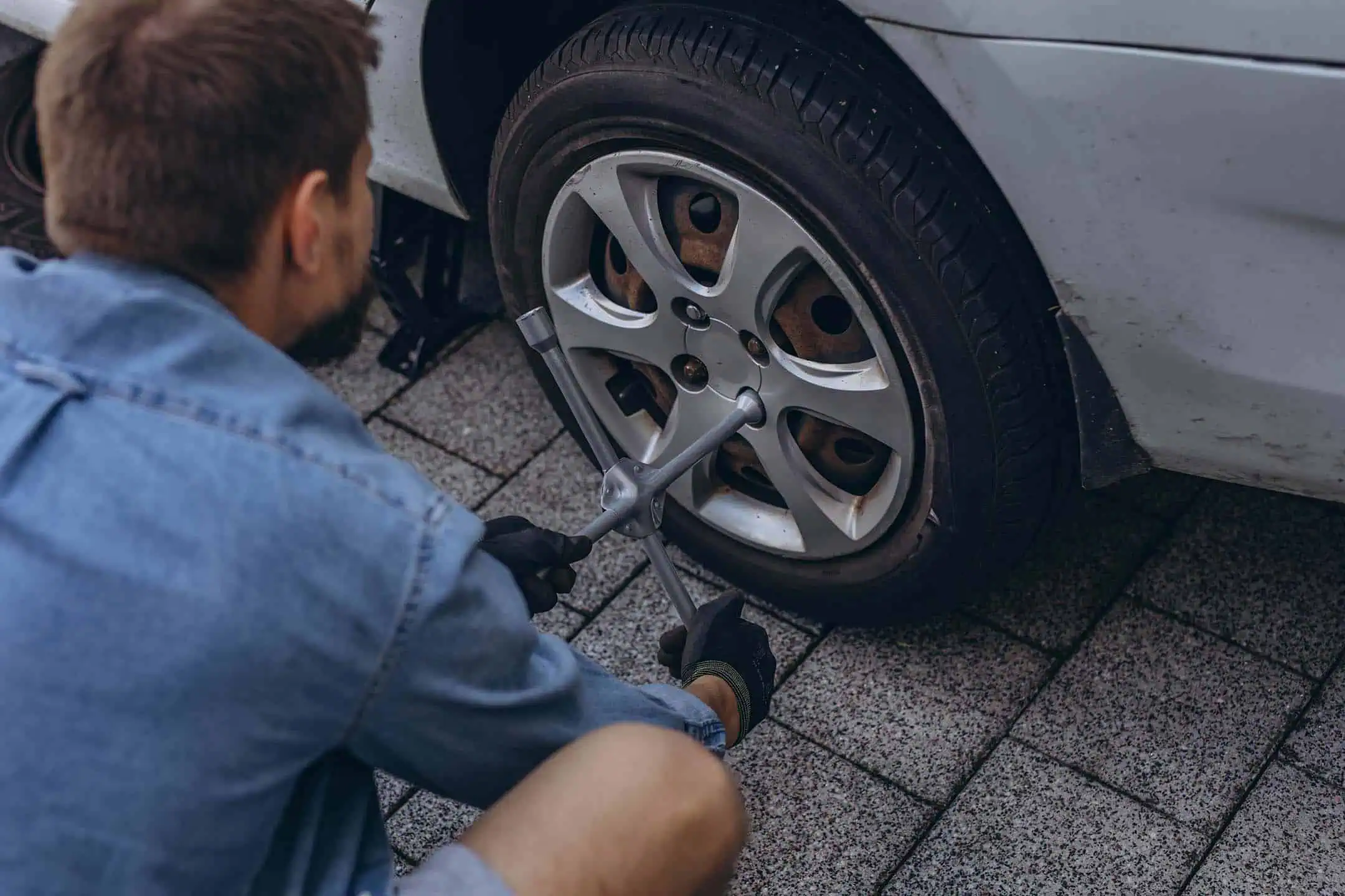 Man Removing Bolts Tyre