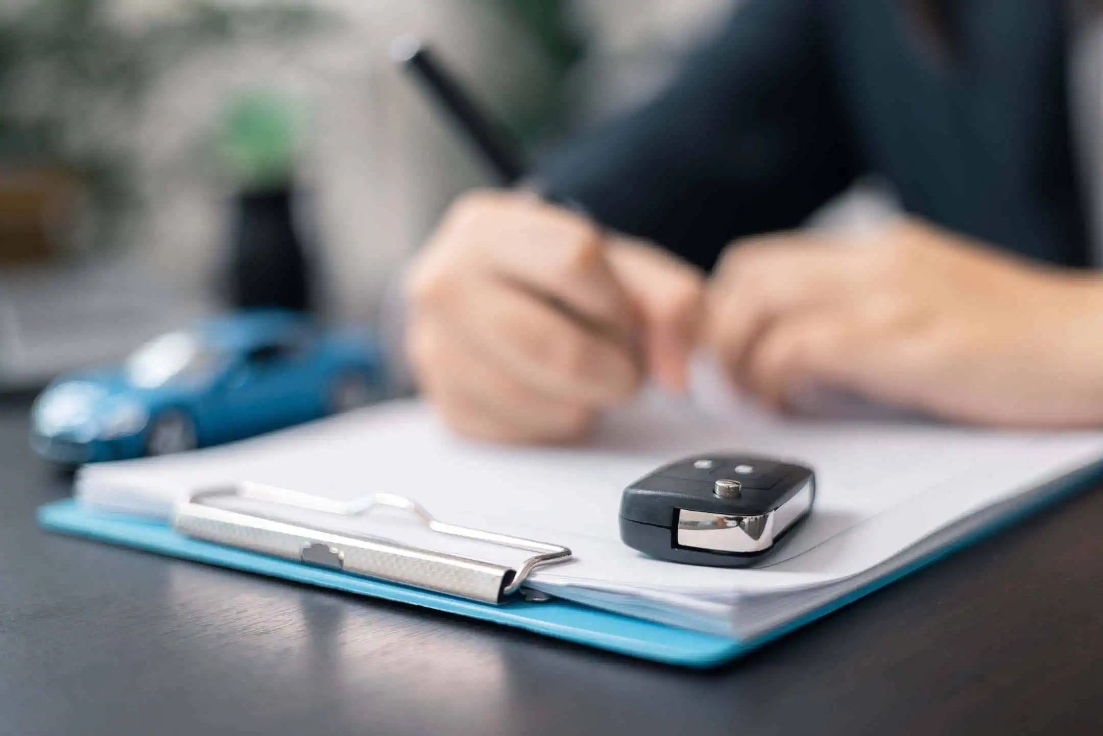 Man Signing Vehicle Contract