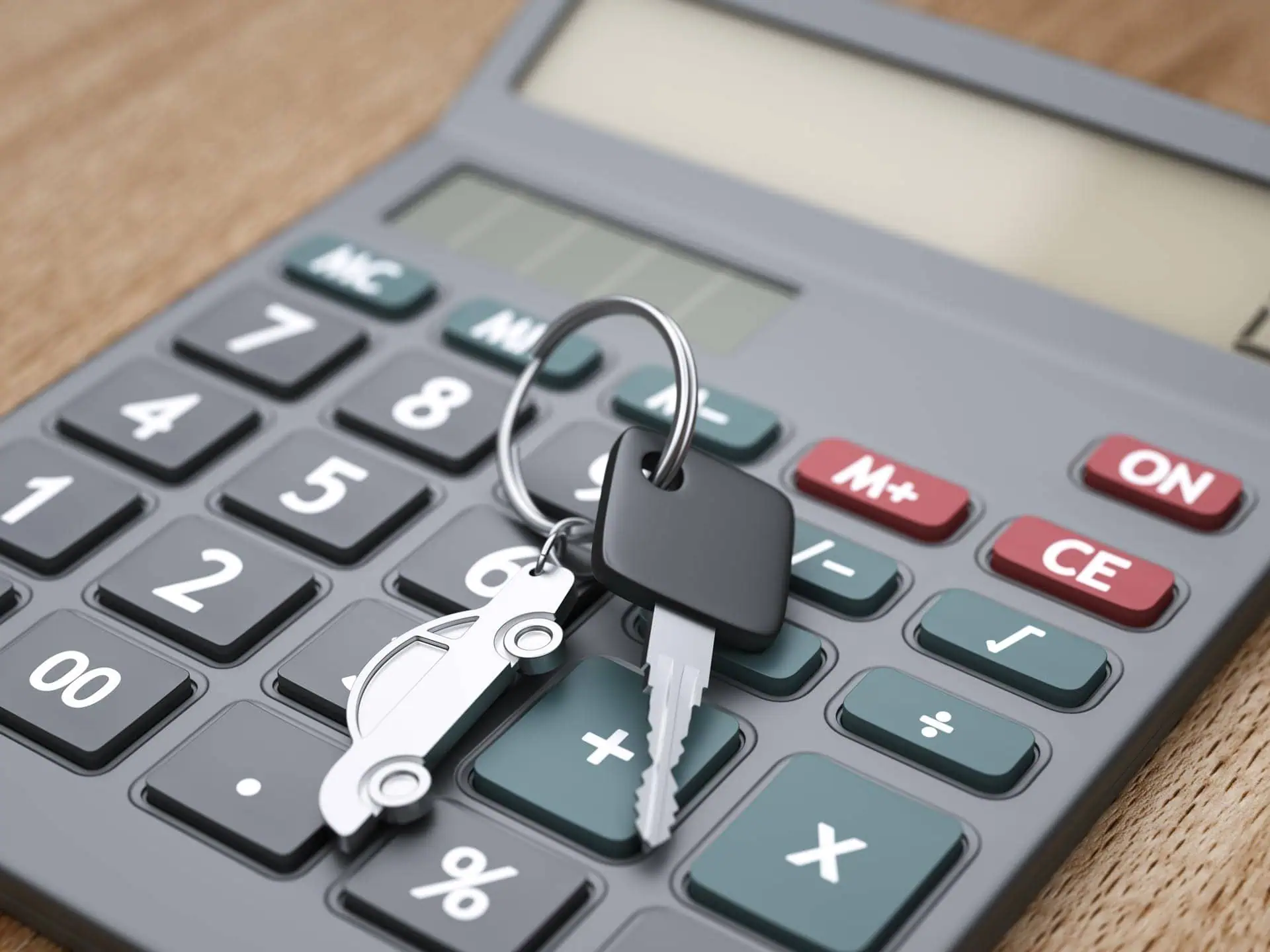 Car Key And Keyring Sitting On Top Of A Calculator