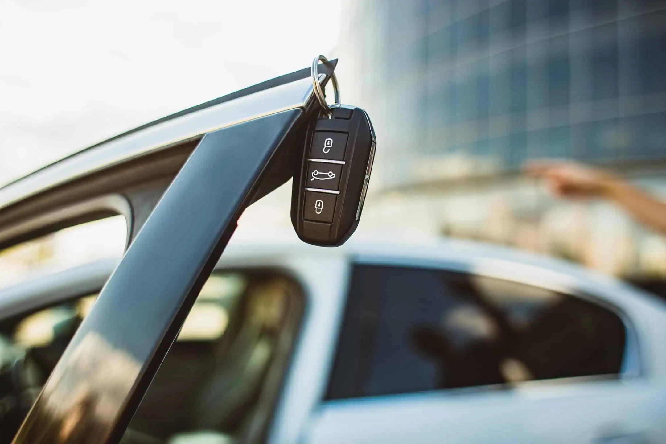 Car Keys Hand On Edge Of Open Car Door