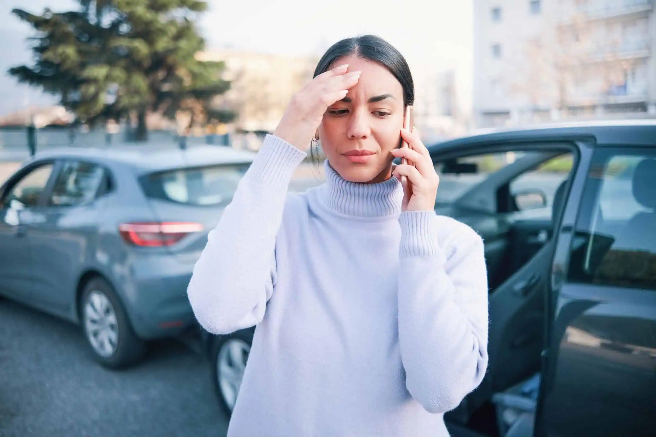 Distressed Woman On Phone In Front Of Car Crash