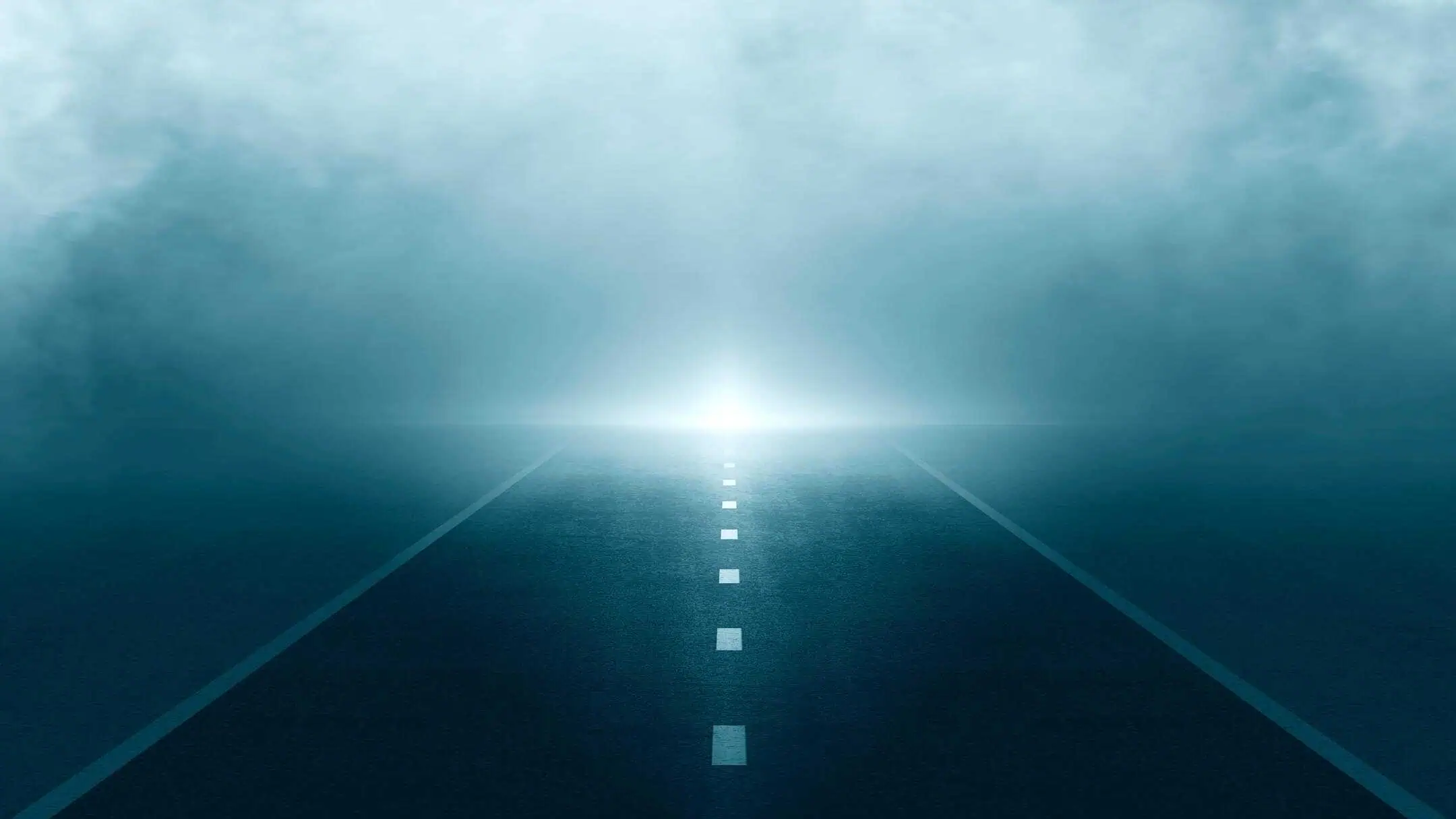 Foggy Road With Headlights Approaching