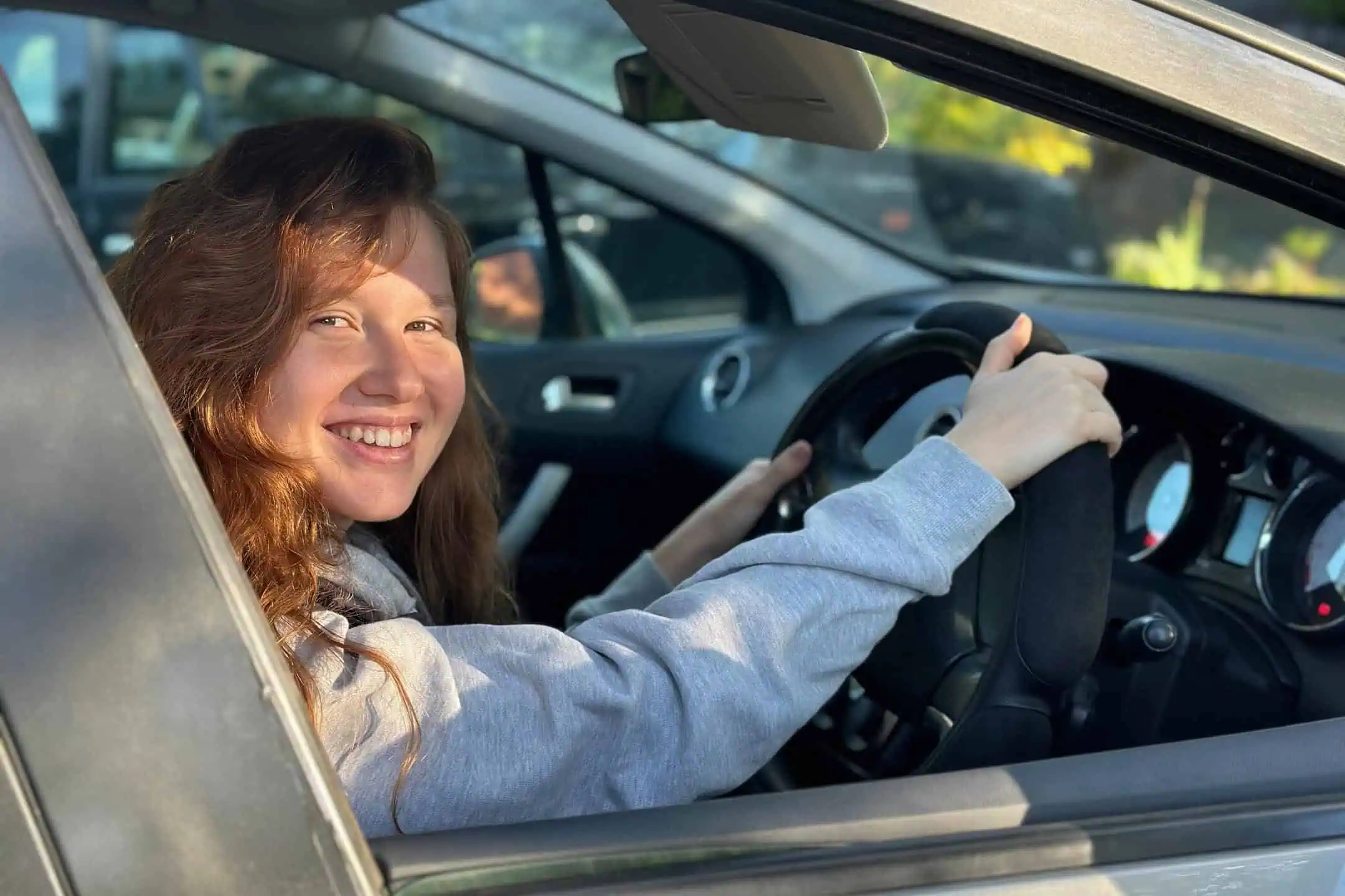 Girl Smiling Looking Out Drivers Window Young Driver