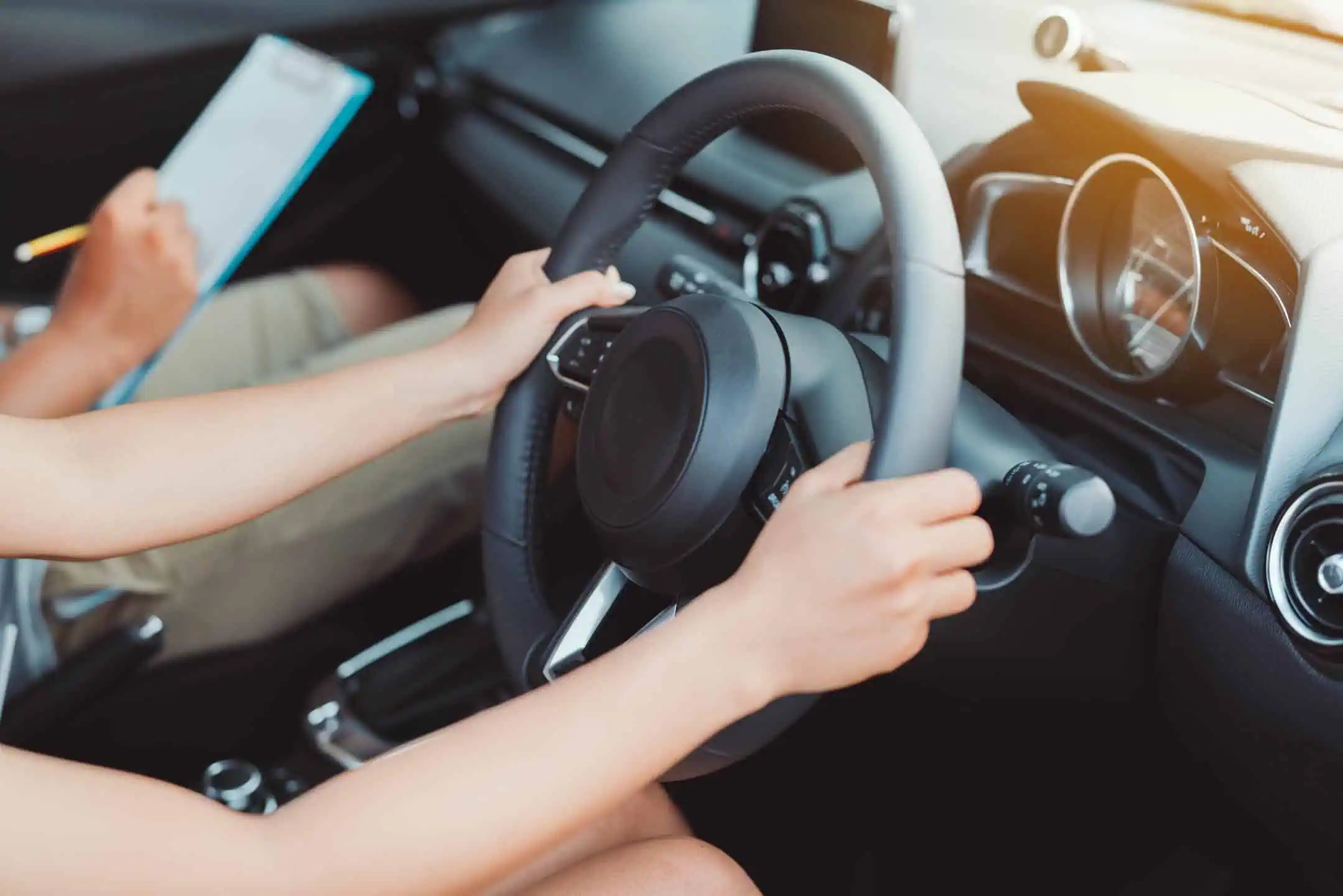 Girls Hands On Sterring Wheel Withinstructor Sitting Next To Her