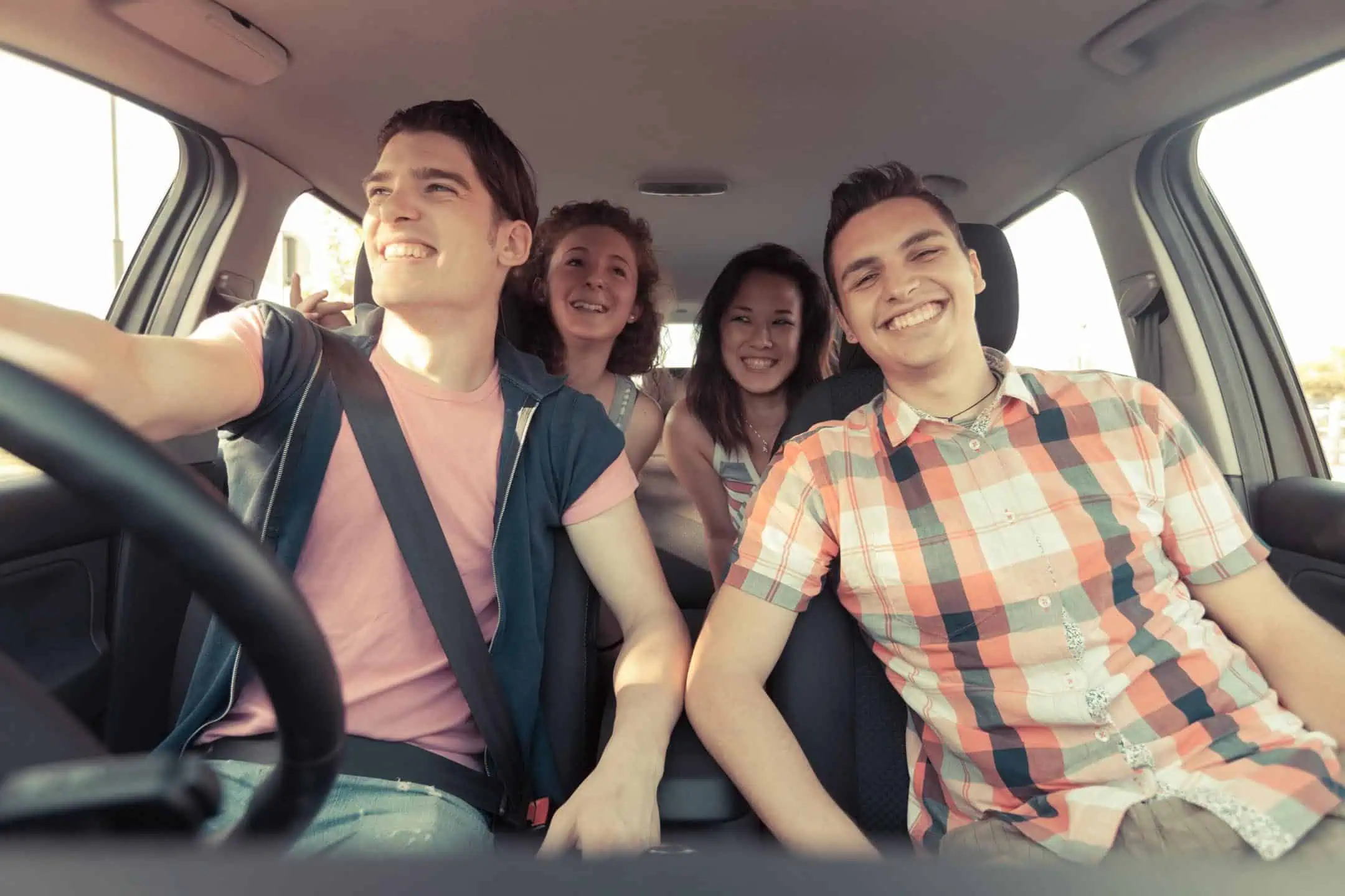 Group Of Young People Enjoying Life In A Car