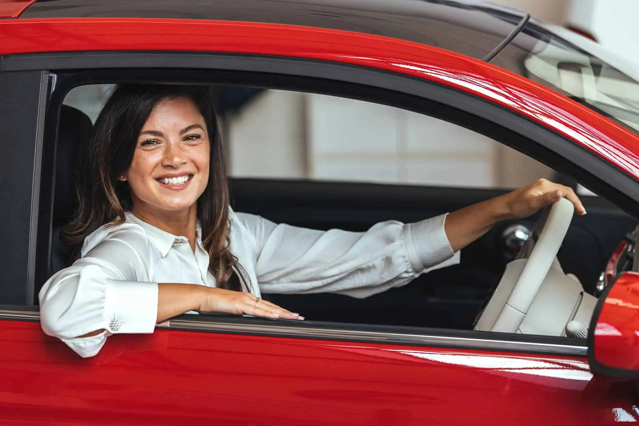 Happy Woman Leaning Out Of Drivers Window