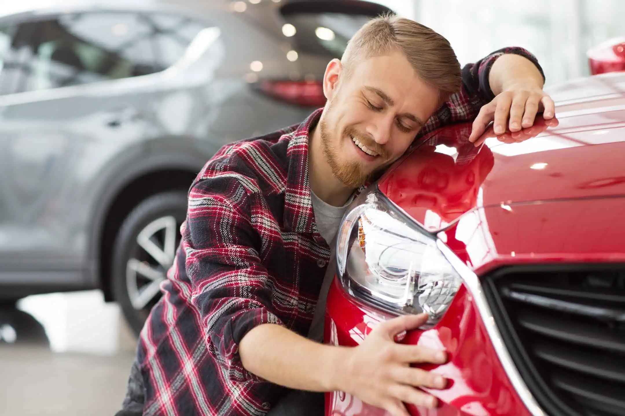 Man Hugging Front Of Red Car