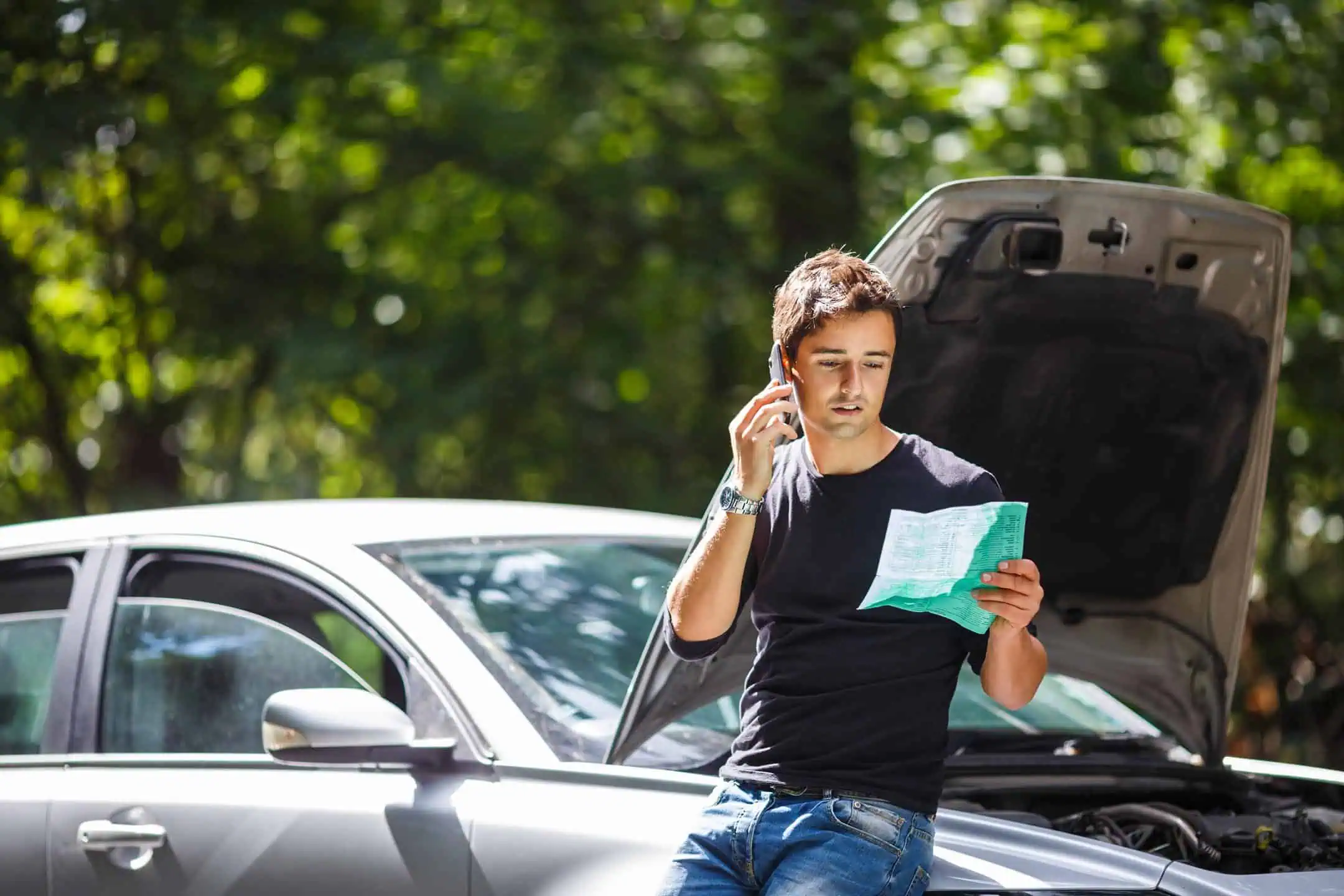 Man On Mobile Looking At Insurance Bonnet Up