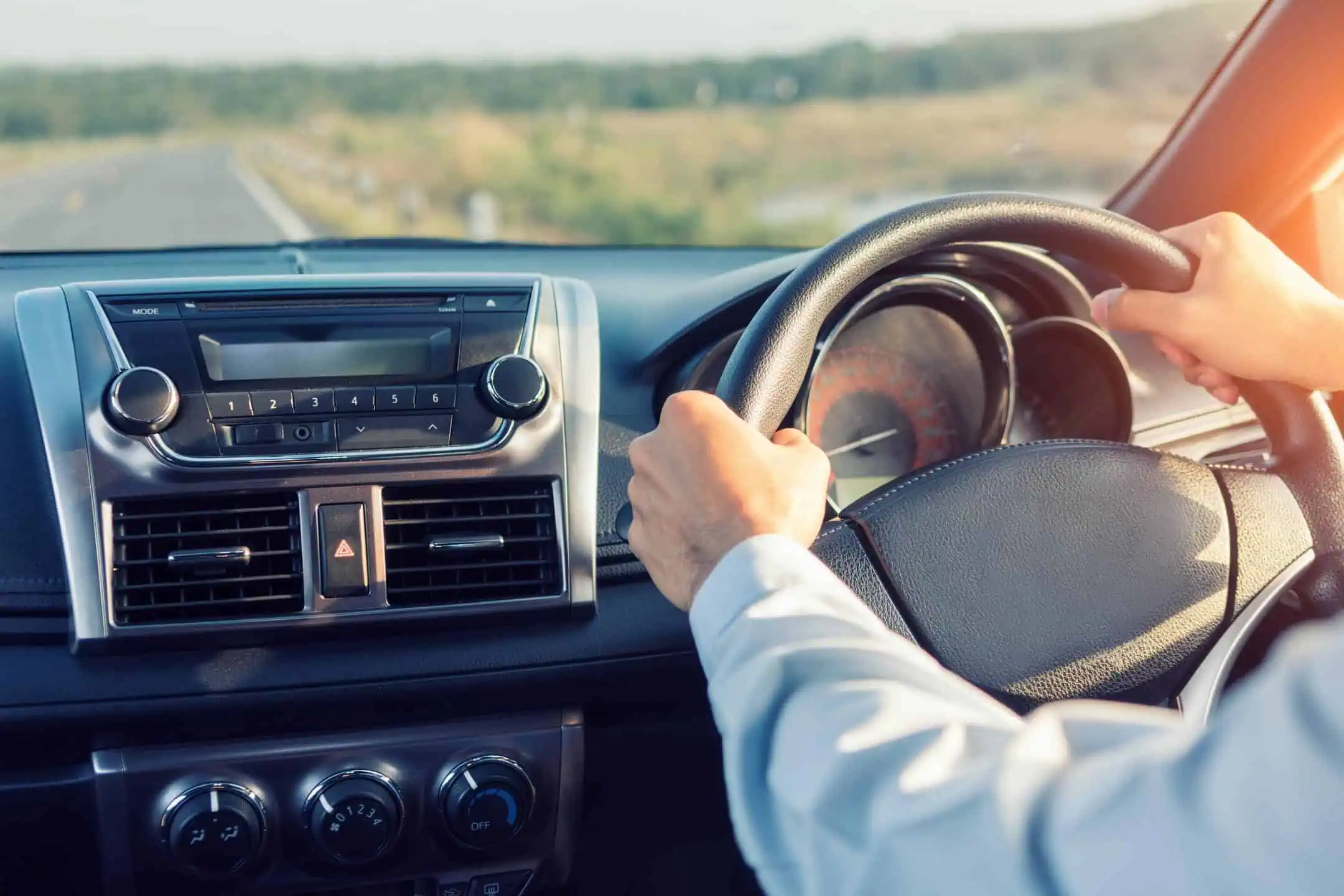 Mans Hands Firmly On Steering Wheel