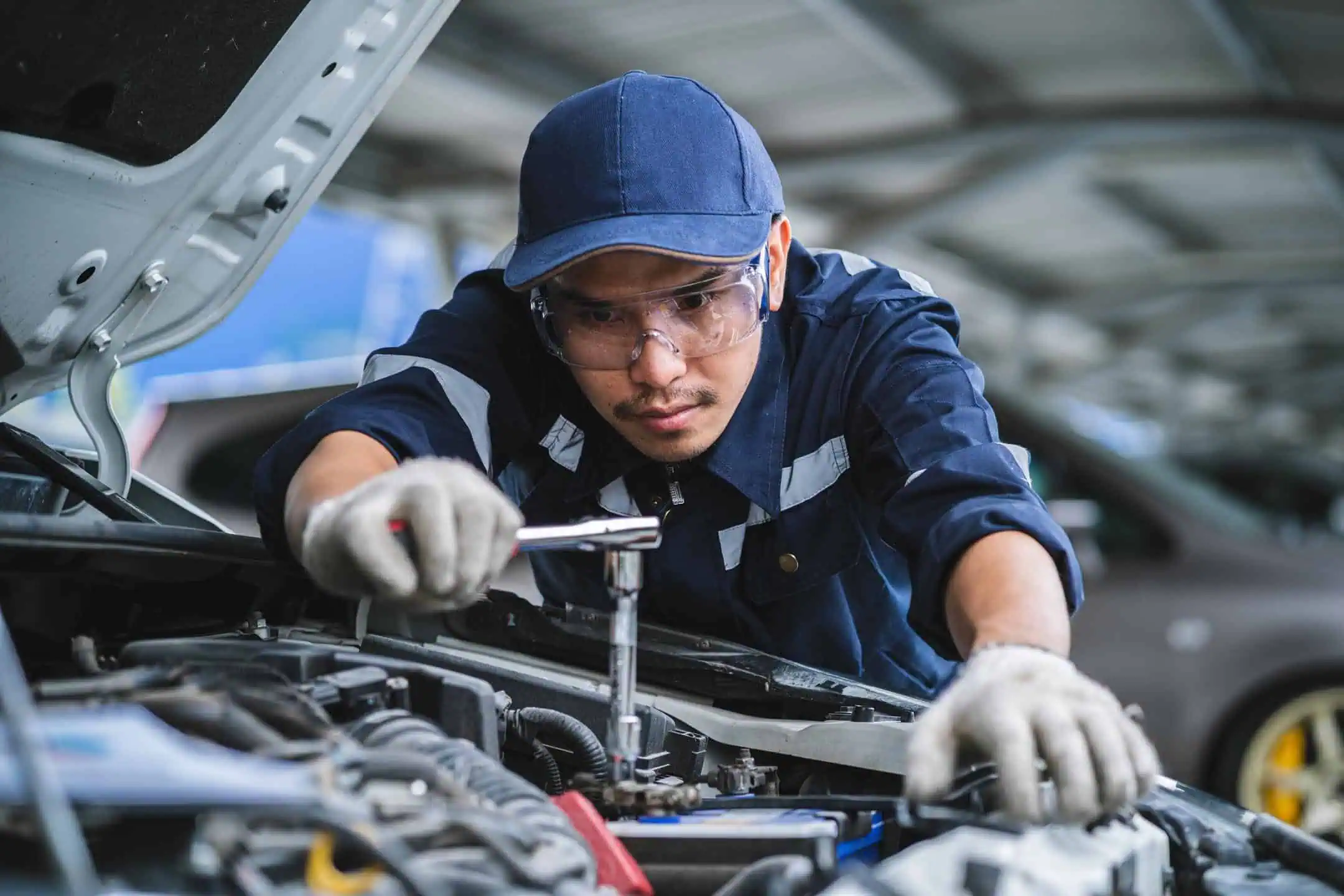 Mechanic Working On Car Engine