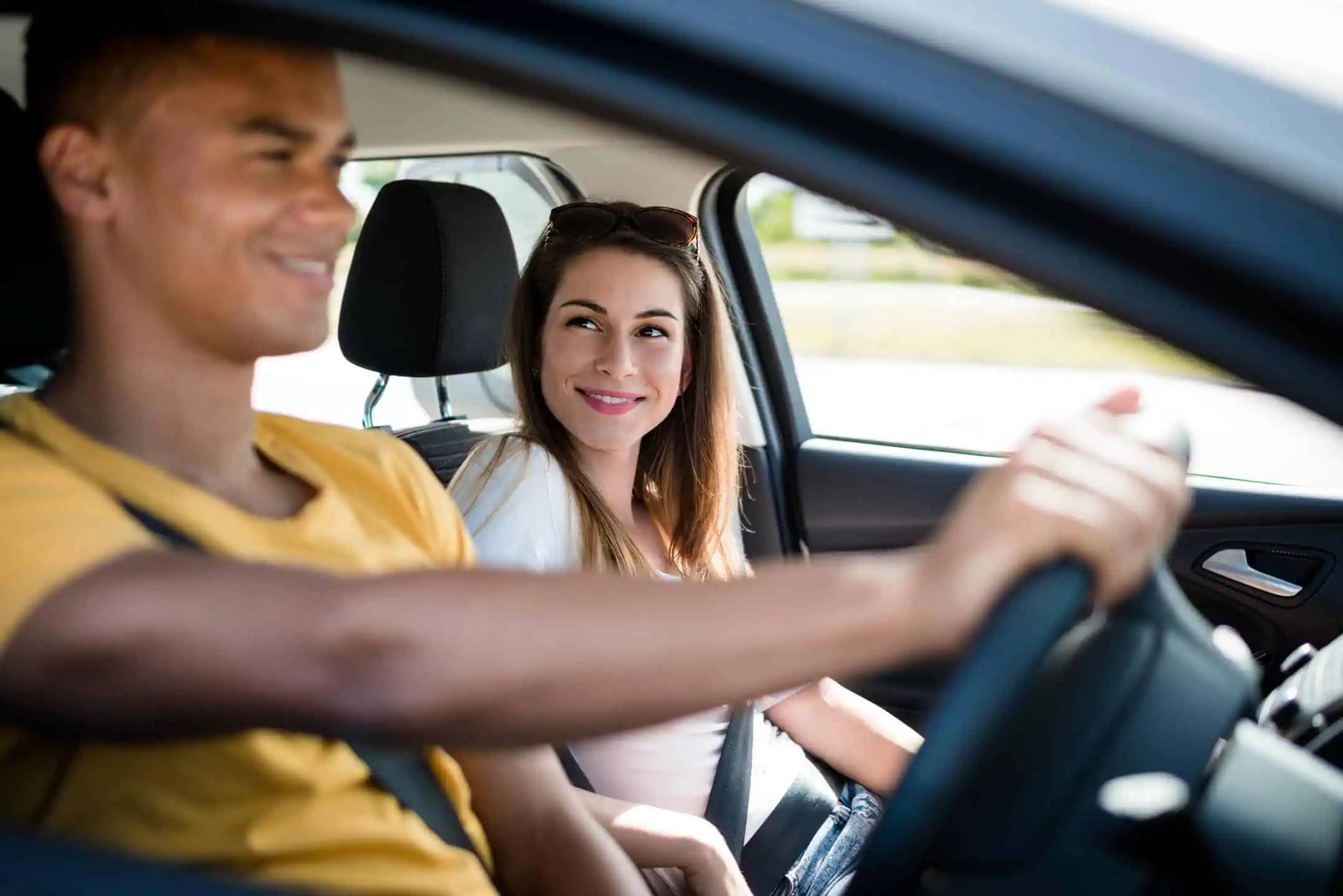 Smiling Girl Looking At The Young Driver In A Car