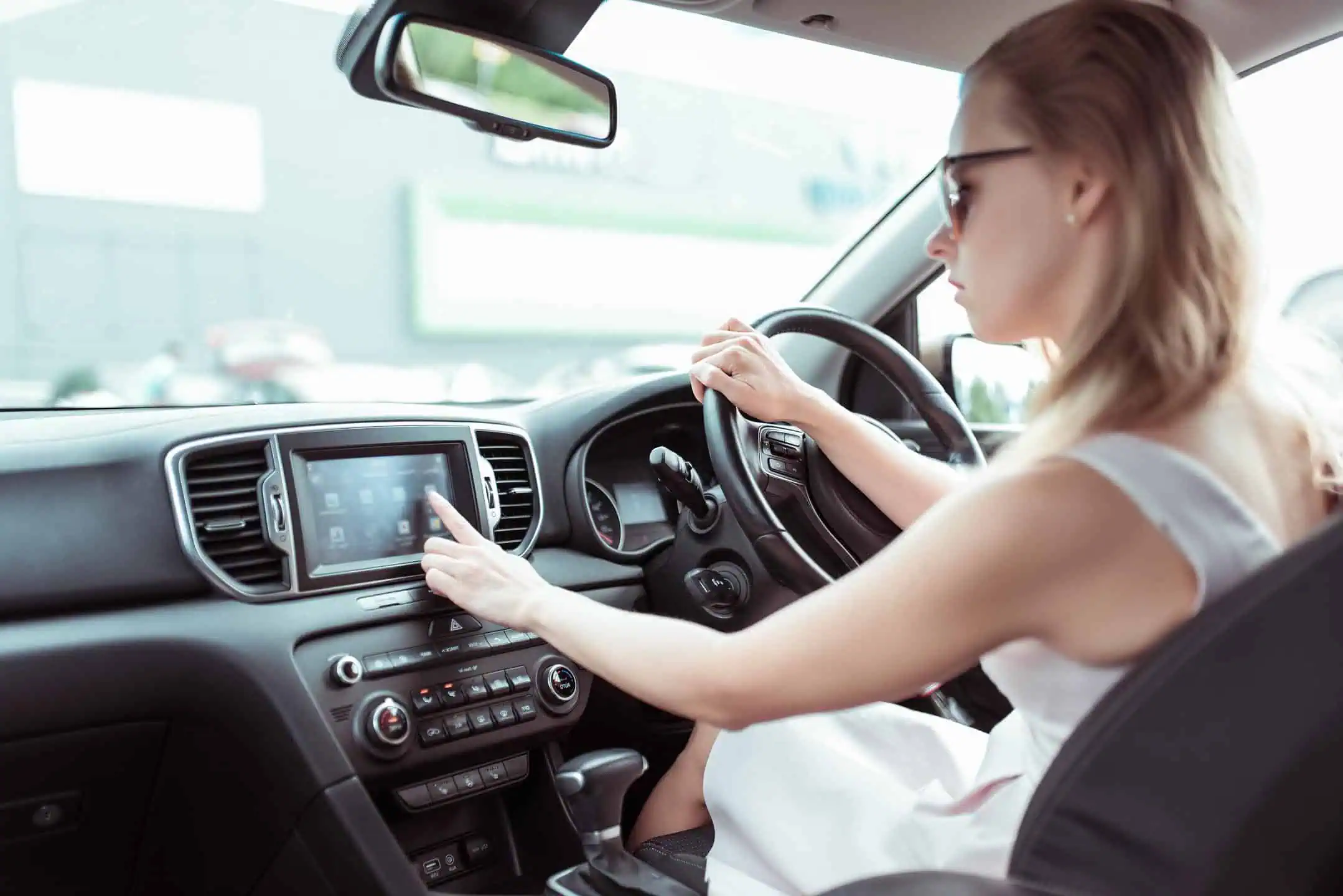 Woman Changing Controls On Car Radio