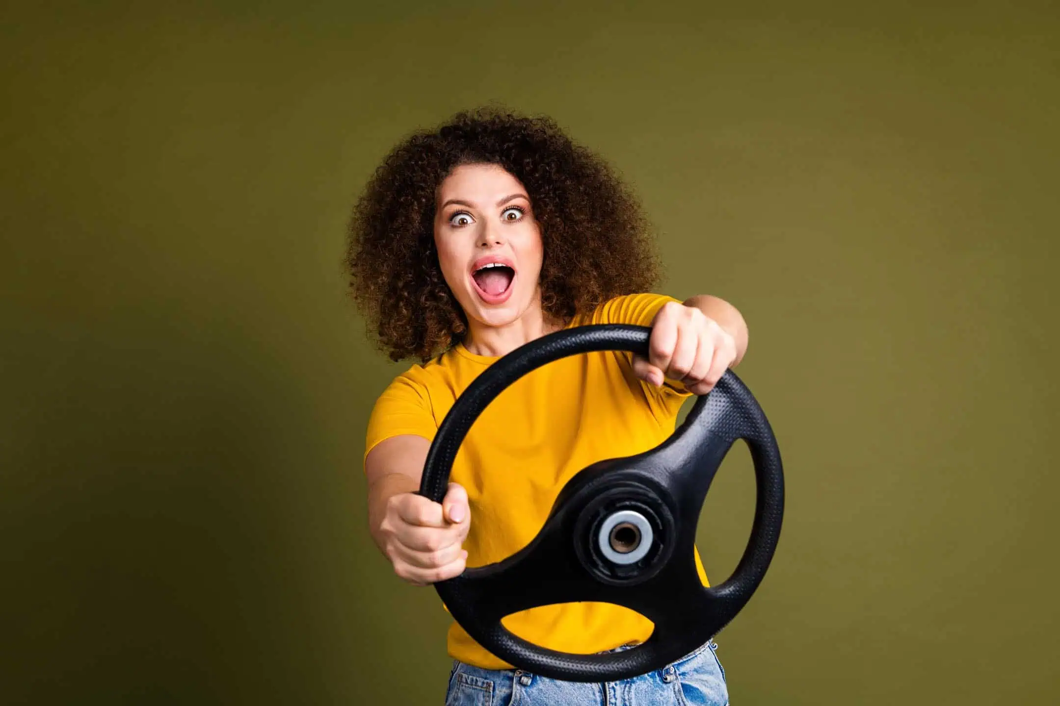 Woman Holding Steering Wheel Navigating the Common myths about Black Box Car Finance