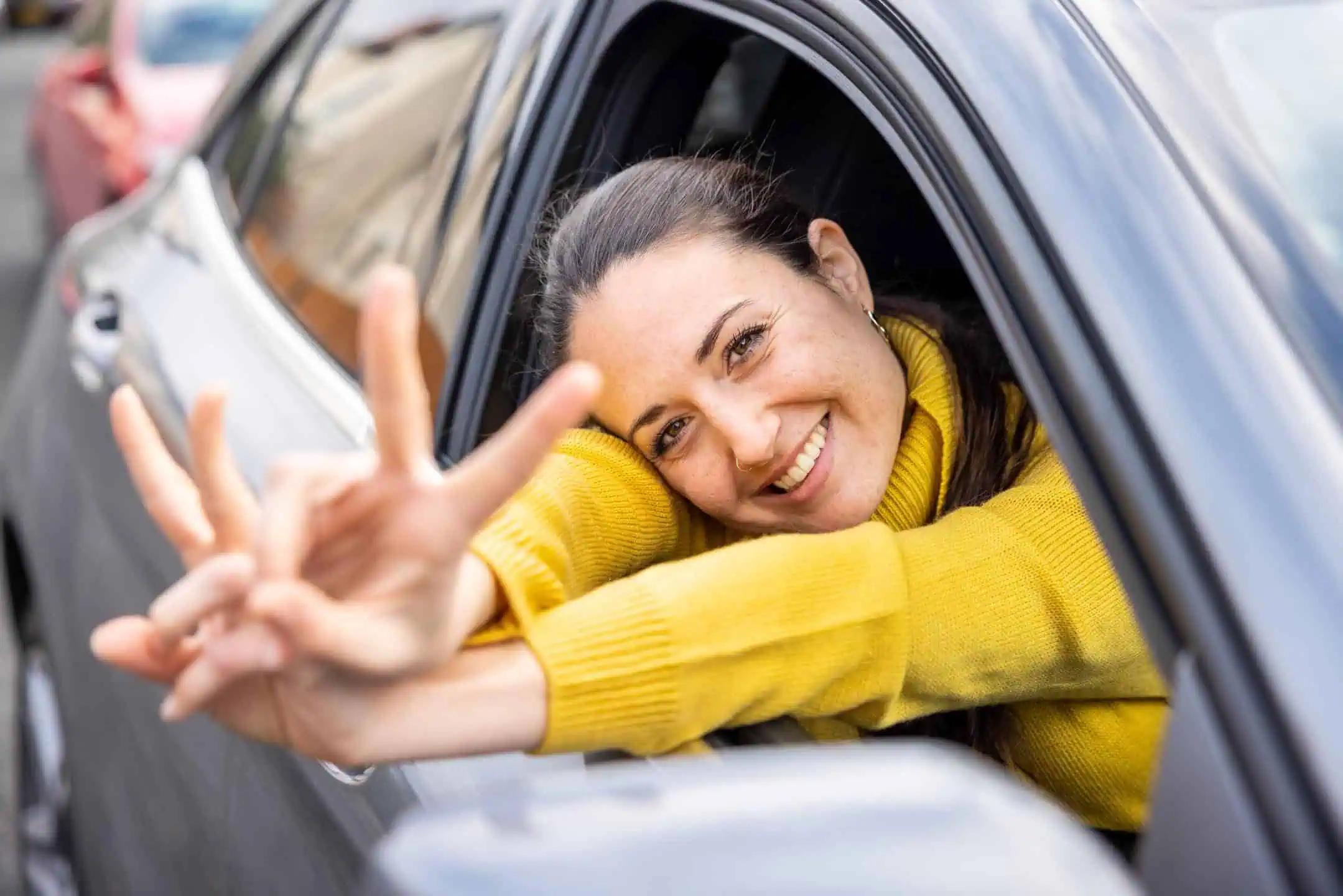 Woman Leaning Out Of Car Happy