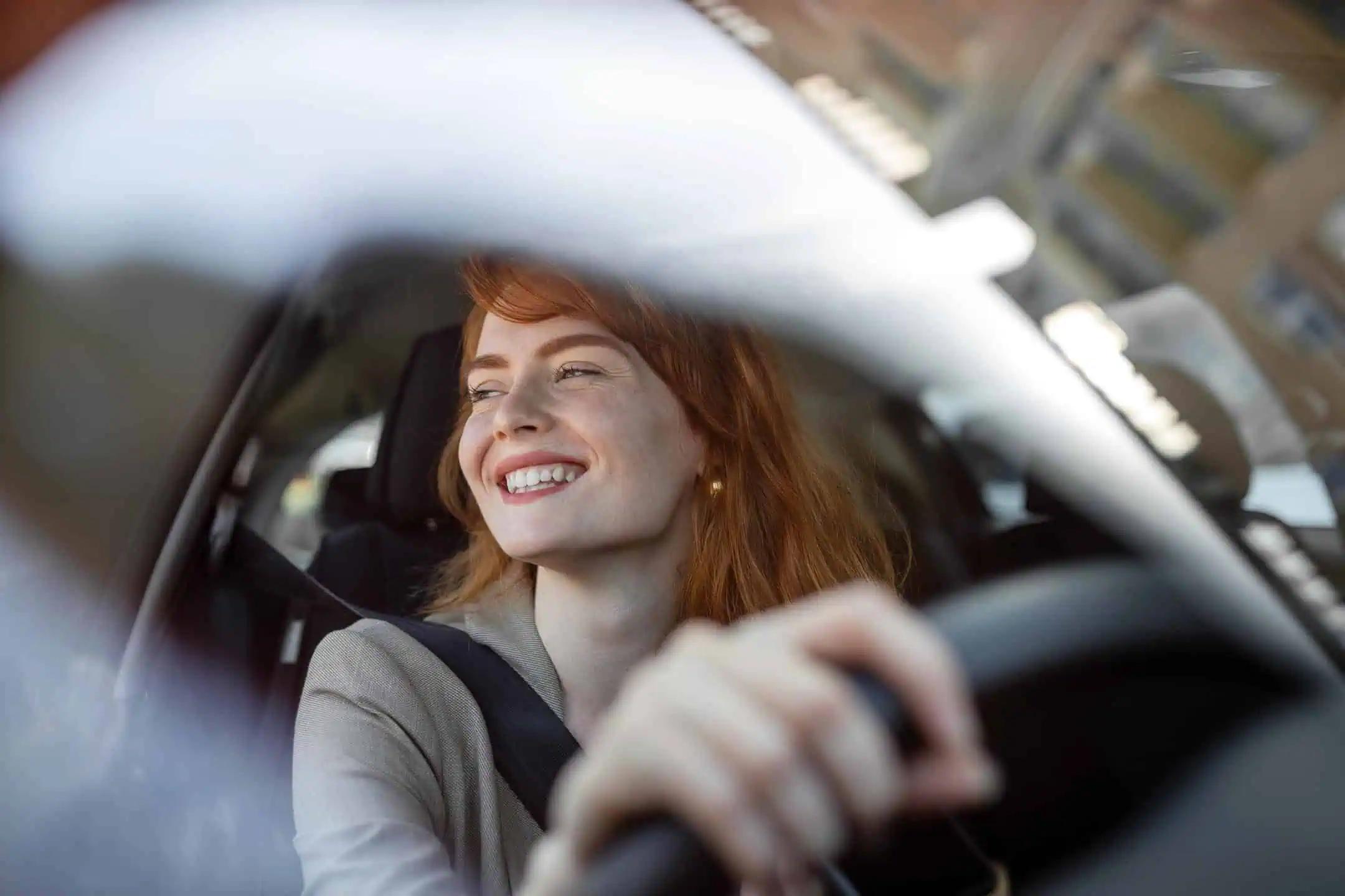 Young Female Looking Happy And Smiling From Car Drivers Window